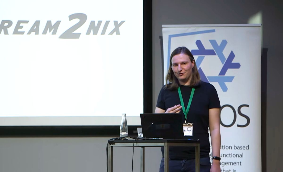 A photo of Yorick van Pelt who is giving a presentation at NixCon 2024 about Dream2Nix